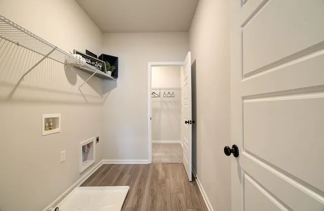 a view of a hallway view with wooden floor and staircase