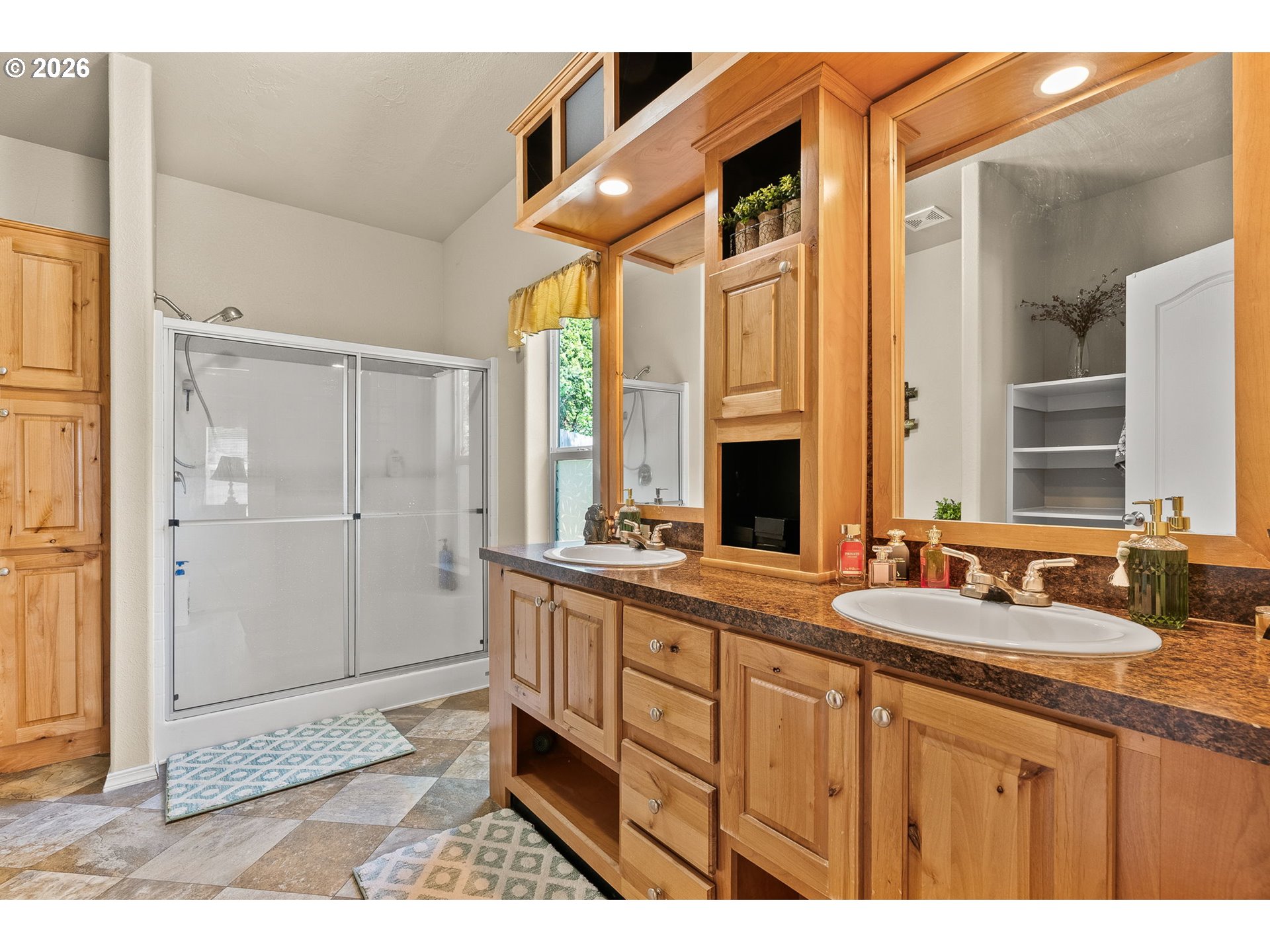 13620 Southwest Beef Bend Road, Unit 1 Portland, OR 97224 - Photo 20 of 34 a bathroom with a sink a mirror and a shower