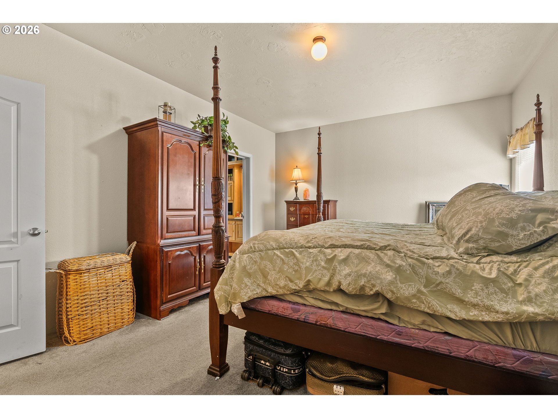 13620 Southwest Beef Bend Road, Unit 1 Portland, OR 97224 - Photo 23 of 34 a bed sitting in a spacious bedroom next to a window