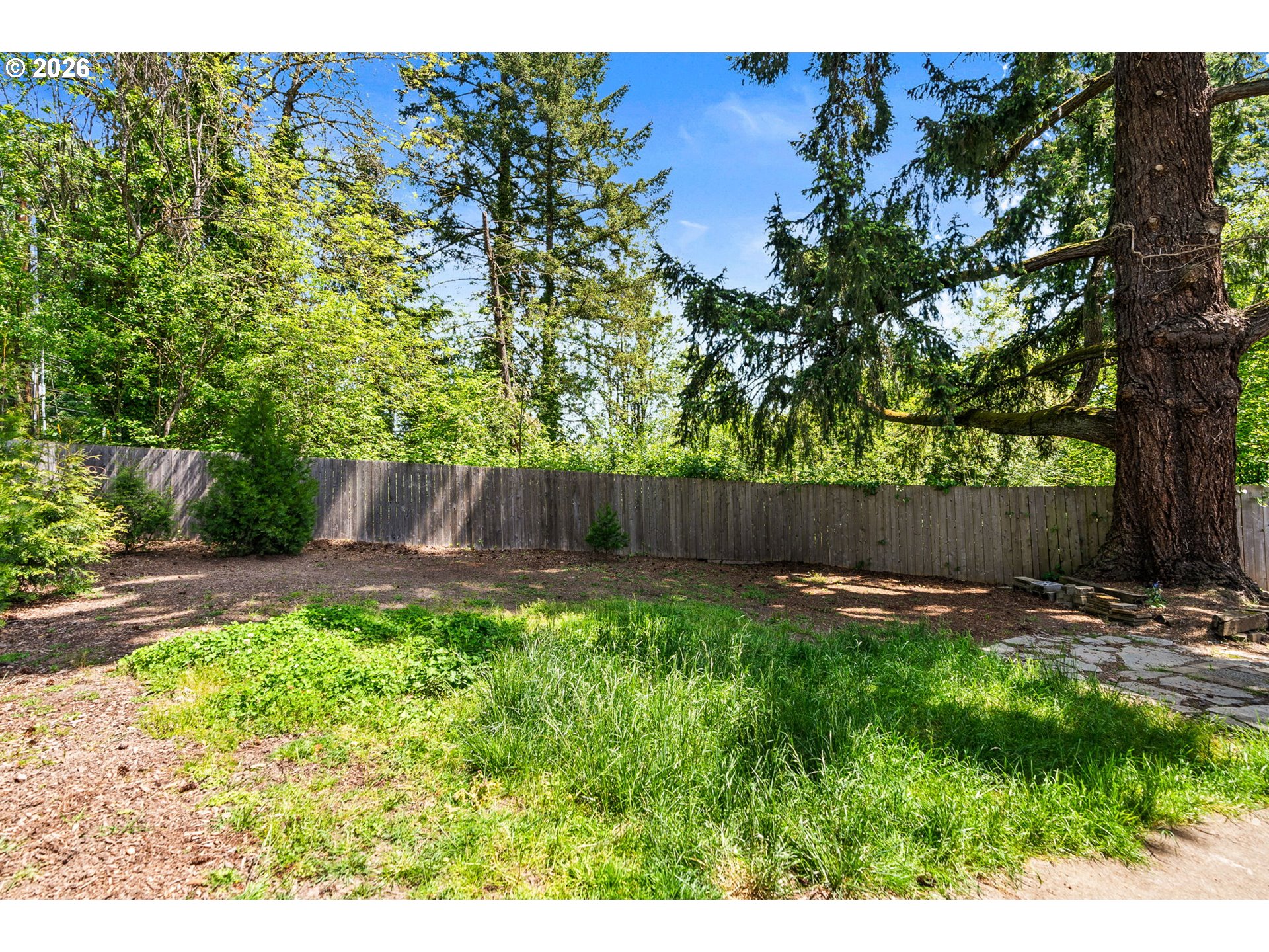 13620 Southwest Beef Bend Road, Unit 1 Portland, OR 97224 - Photo 31 of 34 a backyard of a house with lots of green space