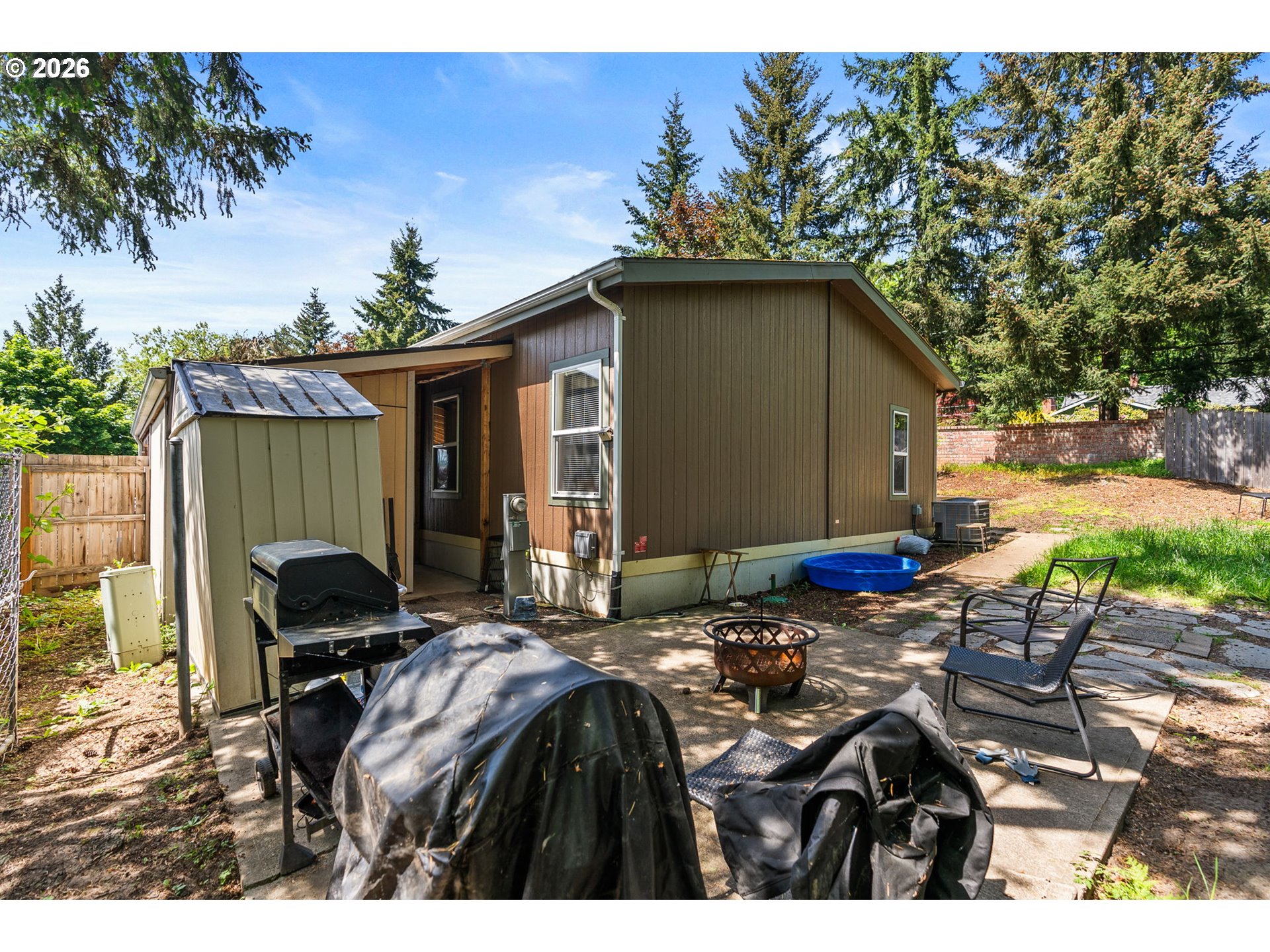13620 Southwest Beef Bend Road, Unit 1 Portland, OR 97224 - Photo 32 of 34 a backyard of a house with table and chairs