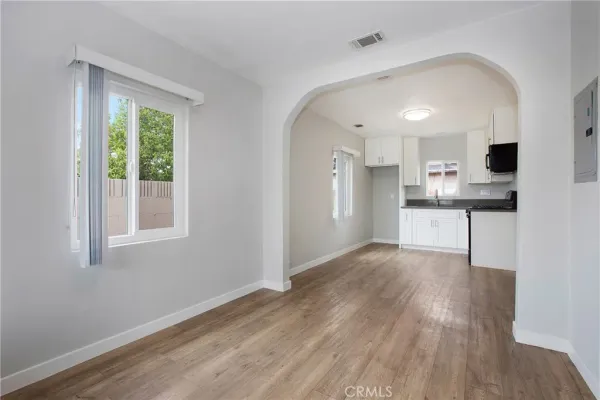 a view of kitchen with wooden floor and electronic appliances