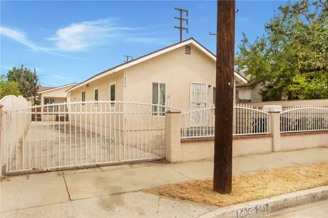 a kitchen with granite countertop a sink a stove top oven and white cabinets