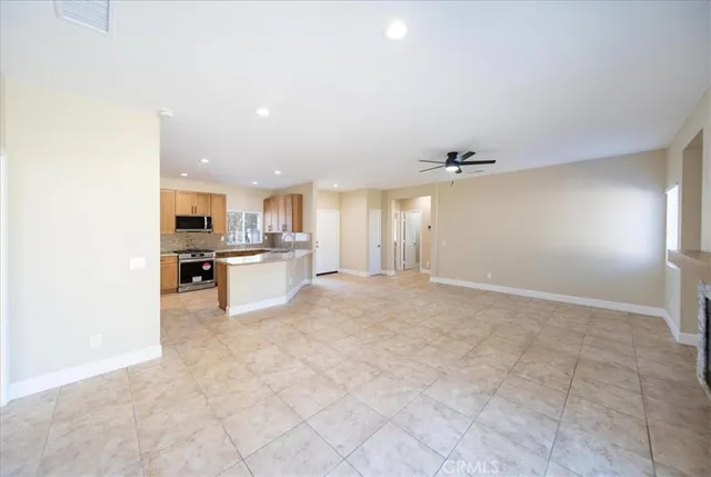 a view of a kitchen with kitchen island and stainless steel appliances