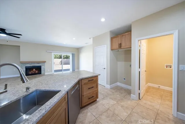 a kitchen with stainless steel appliances granite countertop a refrigerator and a sink
