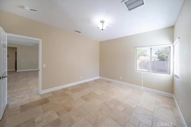 an empty room with windows and closet