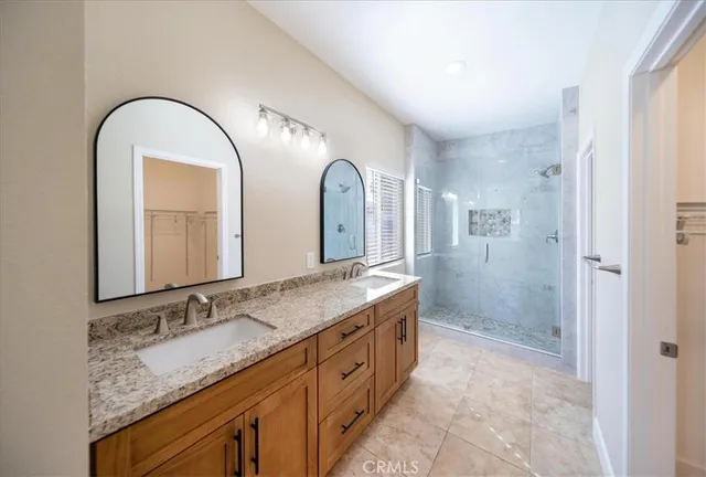a spacious bathroom with a granite countertop sink and a mirror