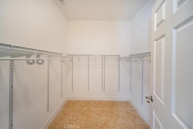 a view of a room with an empty space and a window