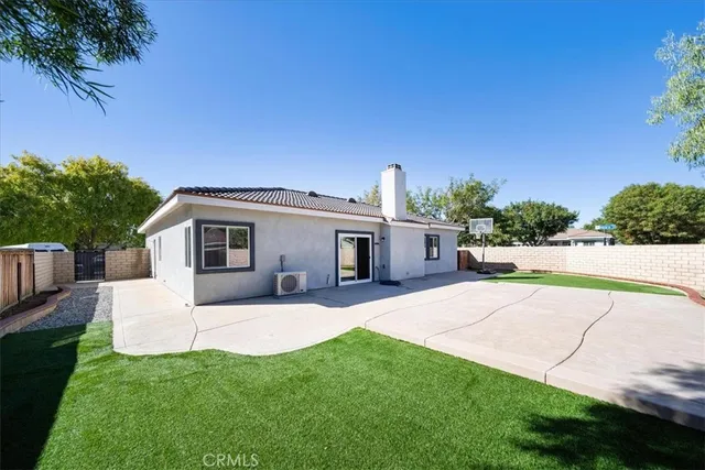 a view of a house with a backyard and a patio