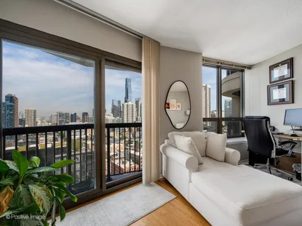 a living room with furniture and a floor to ceiling window