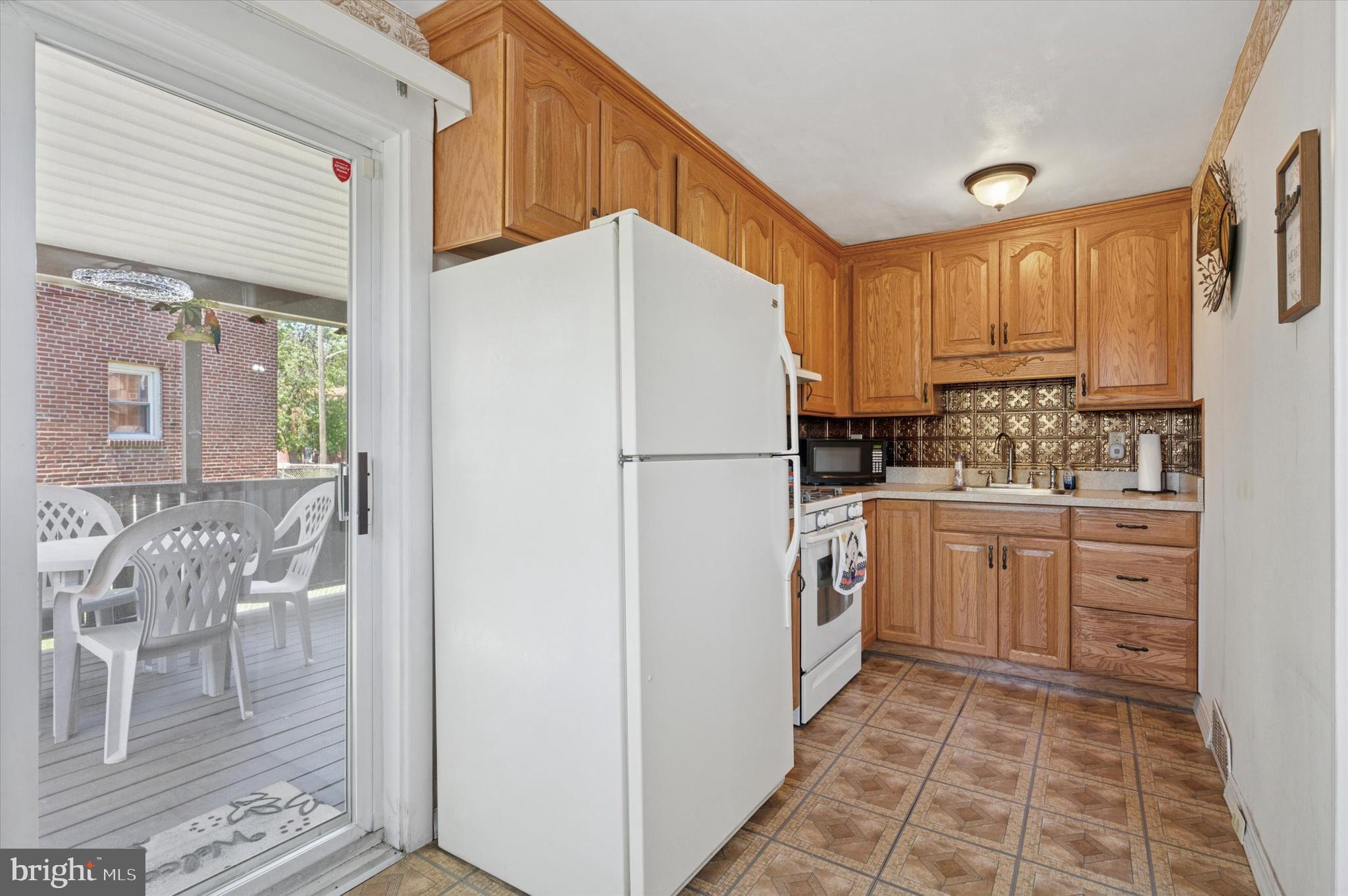 1935 Carter Road Folcroft, PA 19032 - Photo 8 of 15 a kitchen with stainless steel appliances a refrigerator sink and cabinets