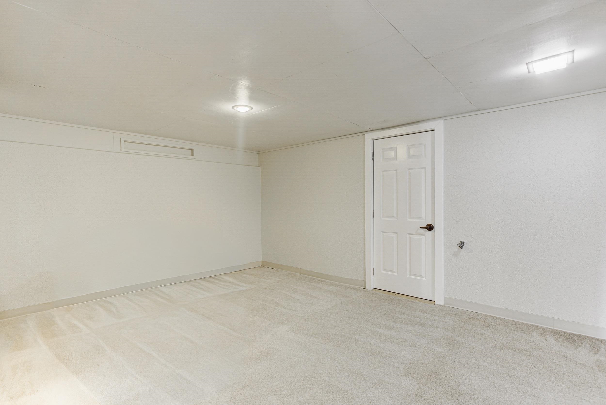 5013 Scheibler Road, Unit C1 Memphis, TN 38128 - Photo 17 of 36 Empty room with light carpet and baseboards