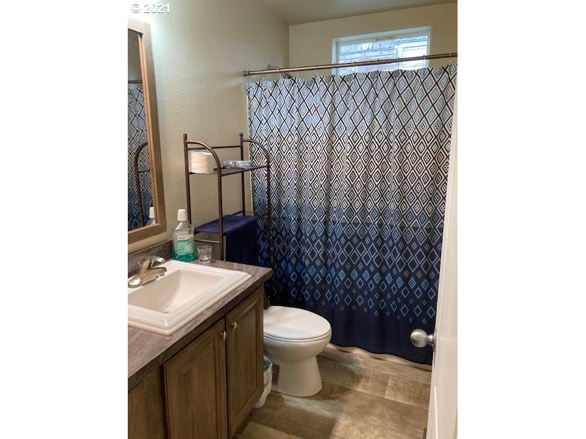 356 Southeast 3rd Street Pendleton, OR 97801 - Photo 14 of 20 a bathroom with a sink a toilet and shower