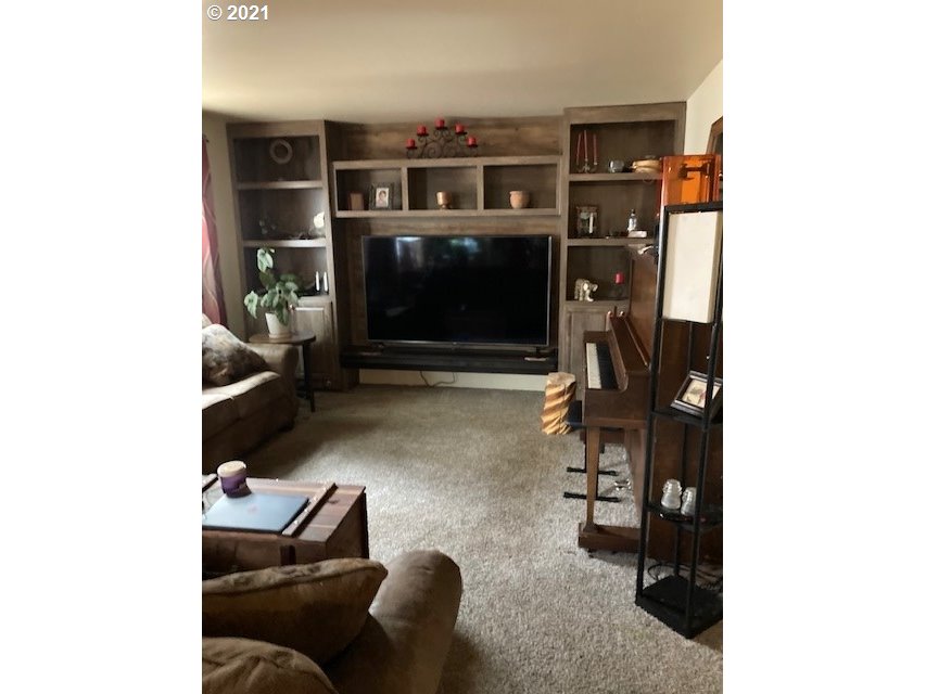 356 Southeast 3rd Street Pendleton, OR 97801 - Photo 3 of 20 a living room with furniture and a fireplace