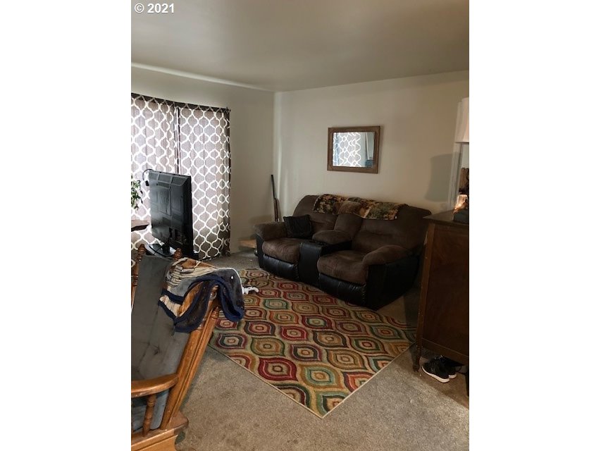 356 Southeast 3rd Street Pendleton, OR 97801 - Photo 8 of 20 a living room with furniture and a flat screen tv