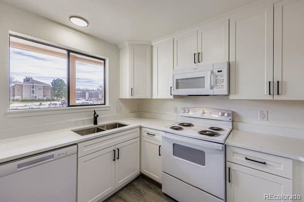 8678 Decatur Street, Unit 275 Westminster, CO 80031 - Photo 13 of 26 a kitchen with white cabinets and white appliances