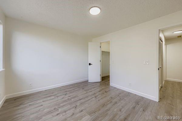 8678 Decatur Street, Unit 275 Westminster, CO 80031 - Photo 18 of 26 a view of an empty room with wooden floor and a window