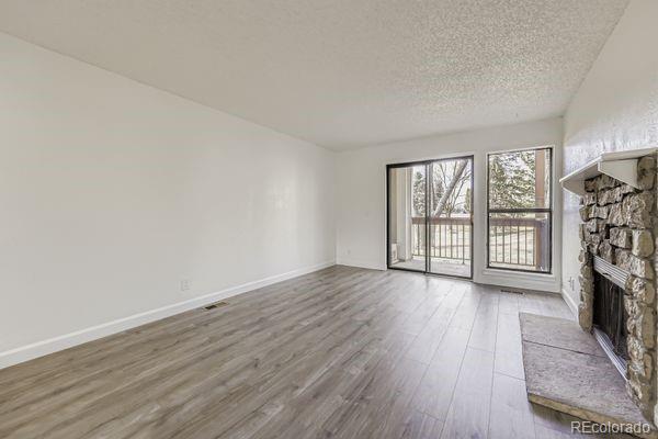 8678 Decatur Street, Unit 275 Westminster, CO 80031 - Photo 3 of 26 wooden floor in an empty room with a window