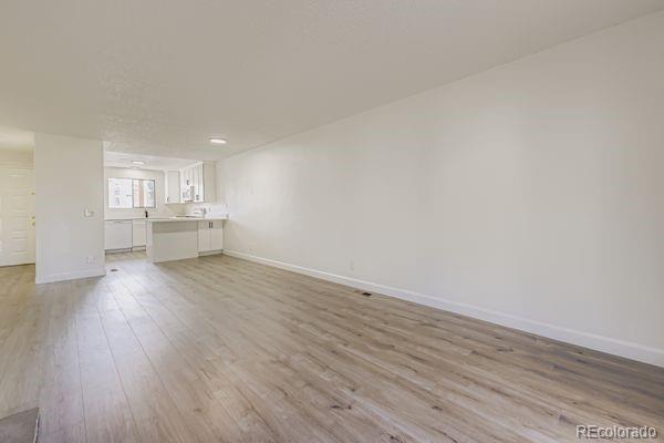 8678 Decatur Street, Unit 275 Westminster, CO 80031 - Photo 5 of 26 a view of empty room with wooden floor