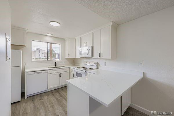 8678 Decatur Street, Unit 275 Westminster, CO 80031 - Photo 9 of 26 a kitchen that has a sink and a stove in it