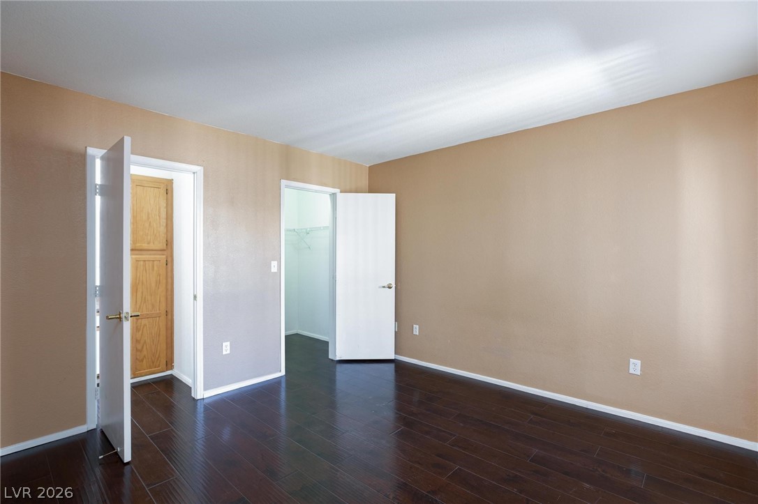 6650 West Warm Springs Road, Unit 2027 Las Vegas, NV 89118 - Photo 15 of 29 This spacious room features rich wood flooring, offering a blank canvas for personalization.