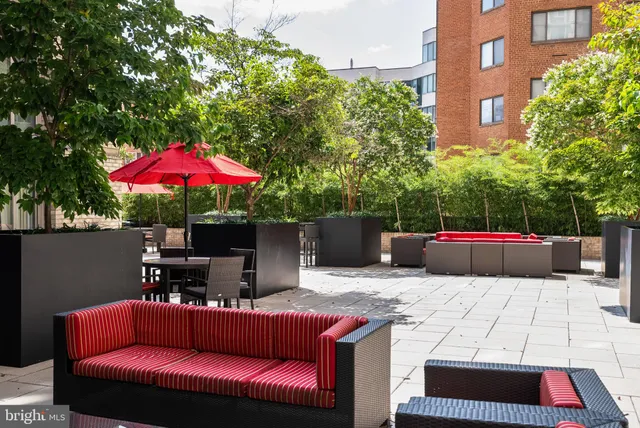 a living room with furniture a mirror and a table