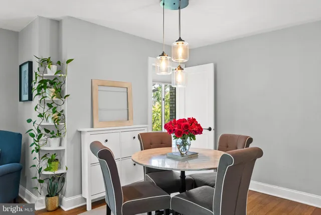 a view of a dining room with furniture and chandelier