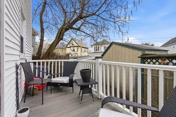 a view of front door of house with outdoor seating