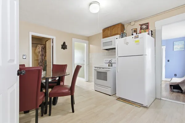 a view of kitchen and dining room with furniture