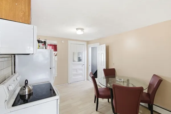 a kitchen with a refrigerator and a stove