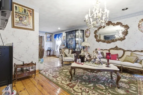 a living room with furniture and a chandelier