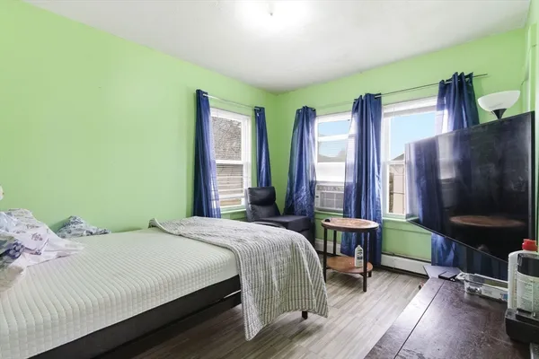 a bedroom with a bed and a flat screen tv