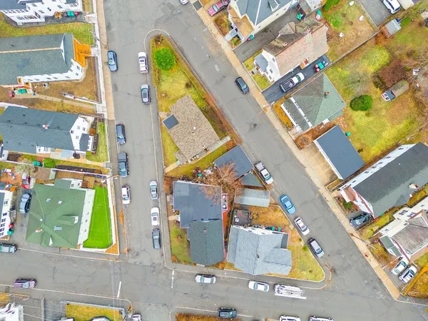 an aerial view of residential houses with city view