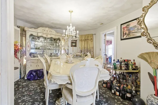 a view of a dining room with furniture and chandelier