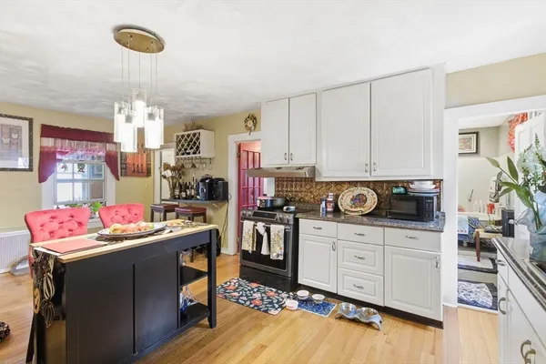 a kitchen with a sink stove and cabinets