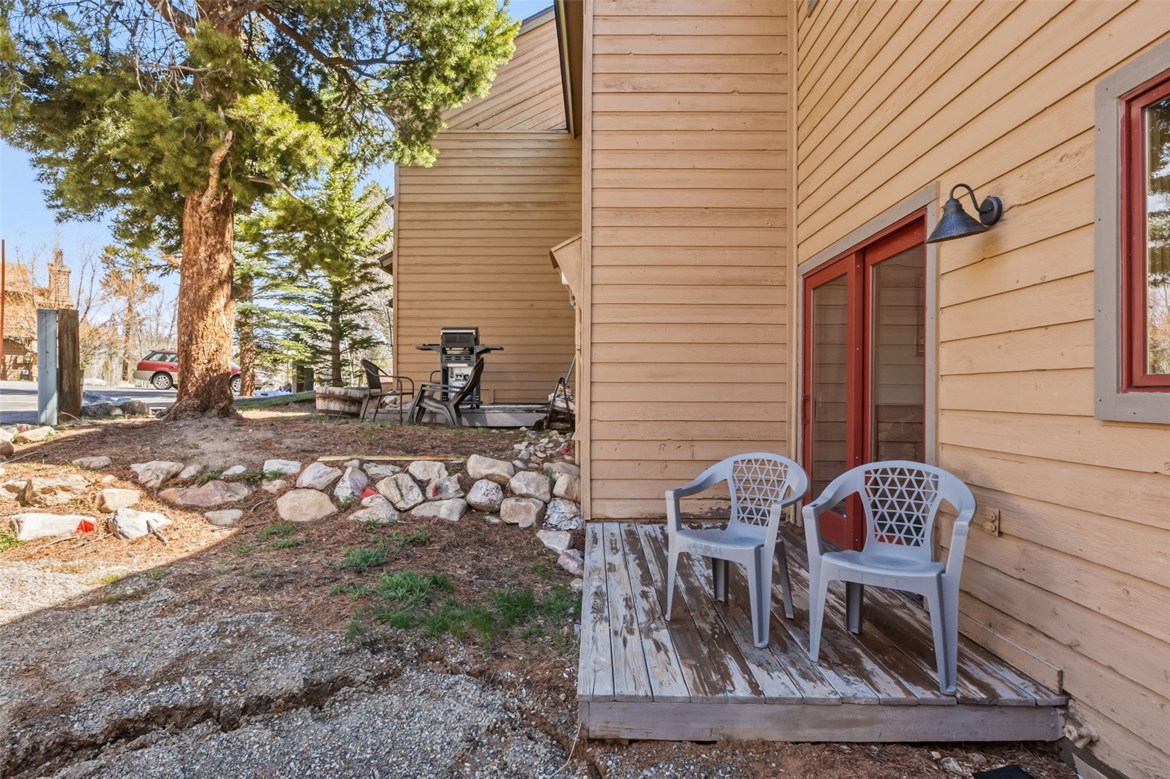 6734 Ryan Gulch Road, Unit 6734 Silverthorne, CO 80498 - Photo 30 of 33 a table and chair sitting in backyard of the house