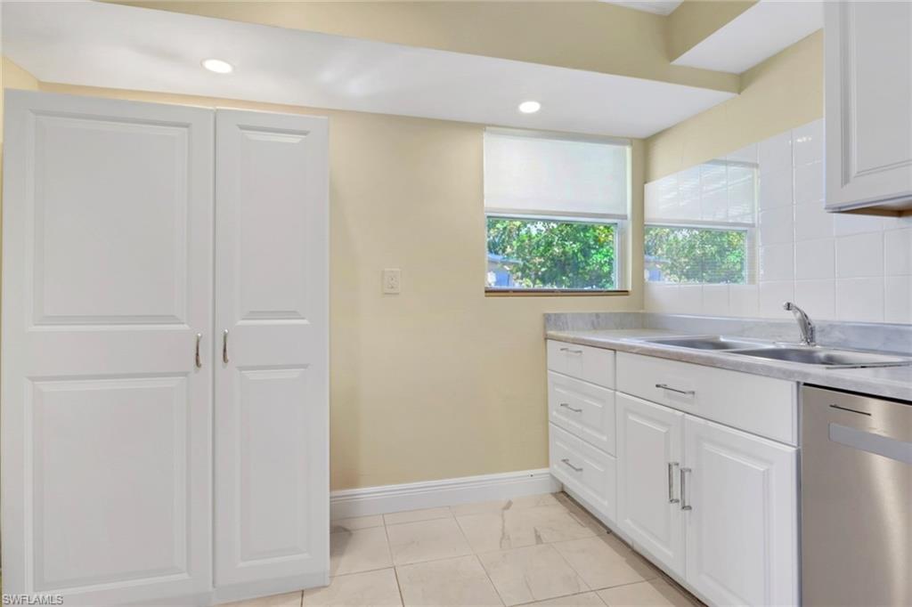 5306 Martin Street Naples, FL 34113 - Photo 38 of 48 a bathroom with a sink and a window