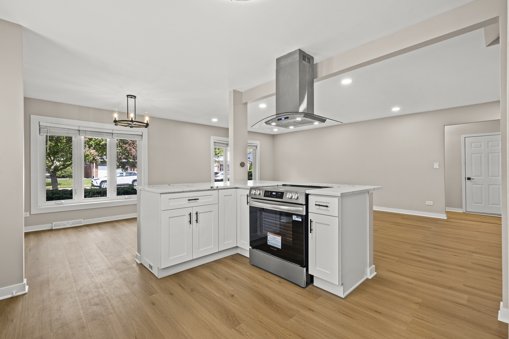 1813 West Pheasant Trail Mount Prospect, IL 60056 - Photo 5 of 31 a kitchen with white cabinets stainless steel appliances and wooden floor