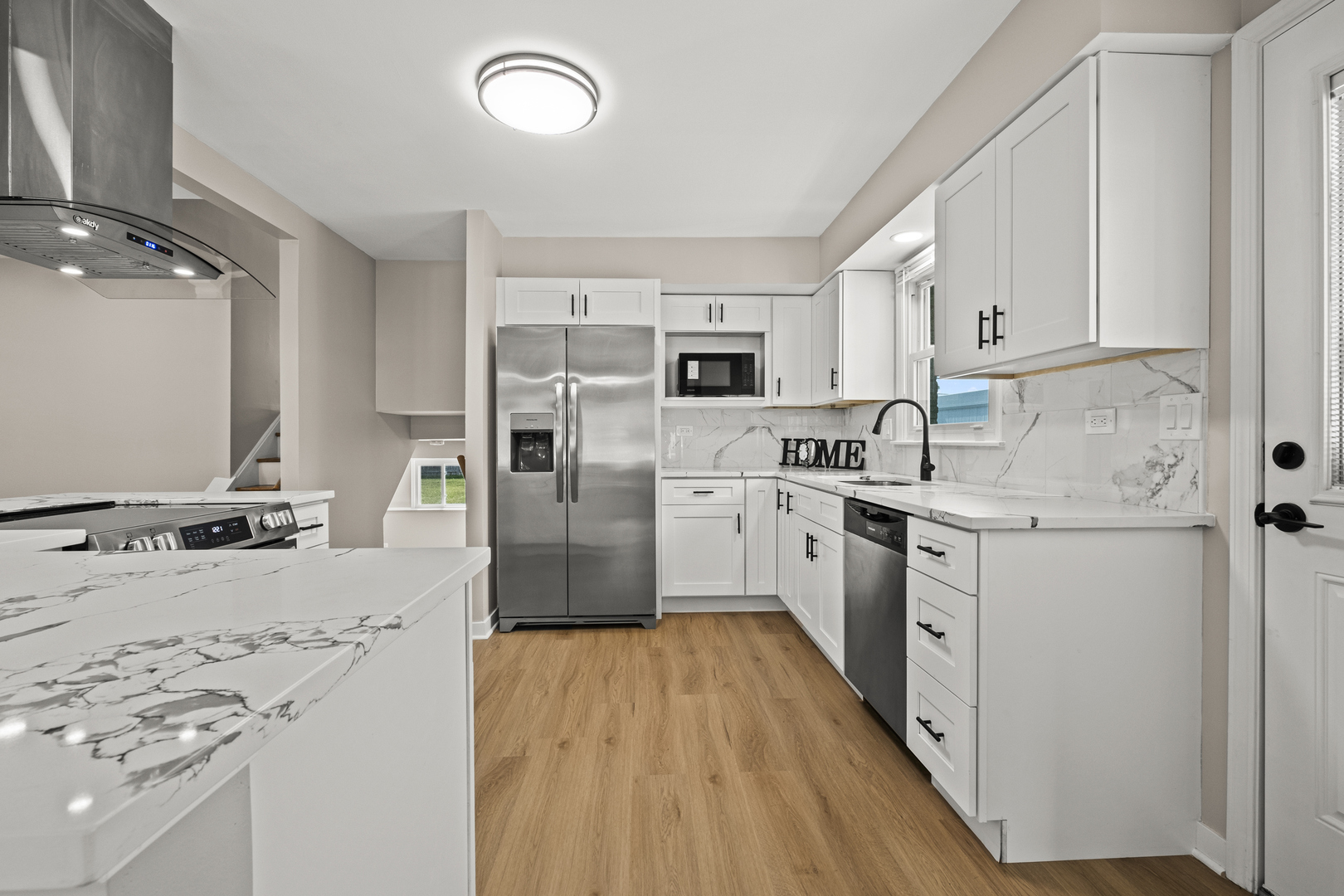 1813 West Pheasant Trail Mount Prospect, IL 60056 - Photo 6 of 31 a kitchen with kitchen island granite countertop a sink appliances cabinets and a counter space