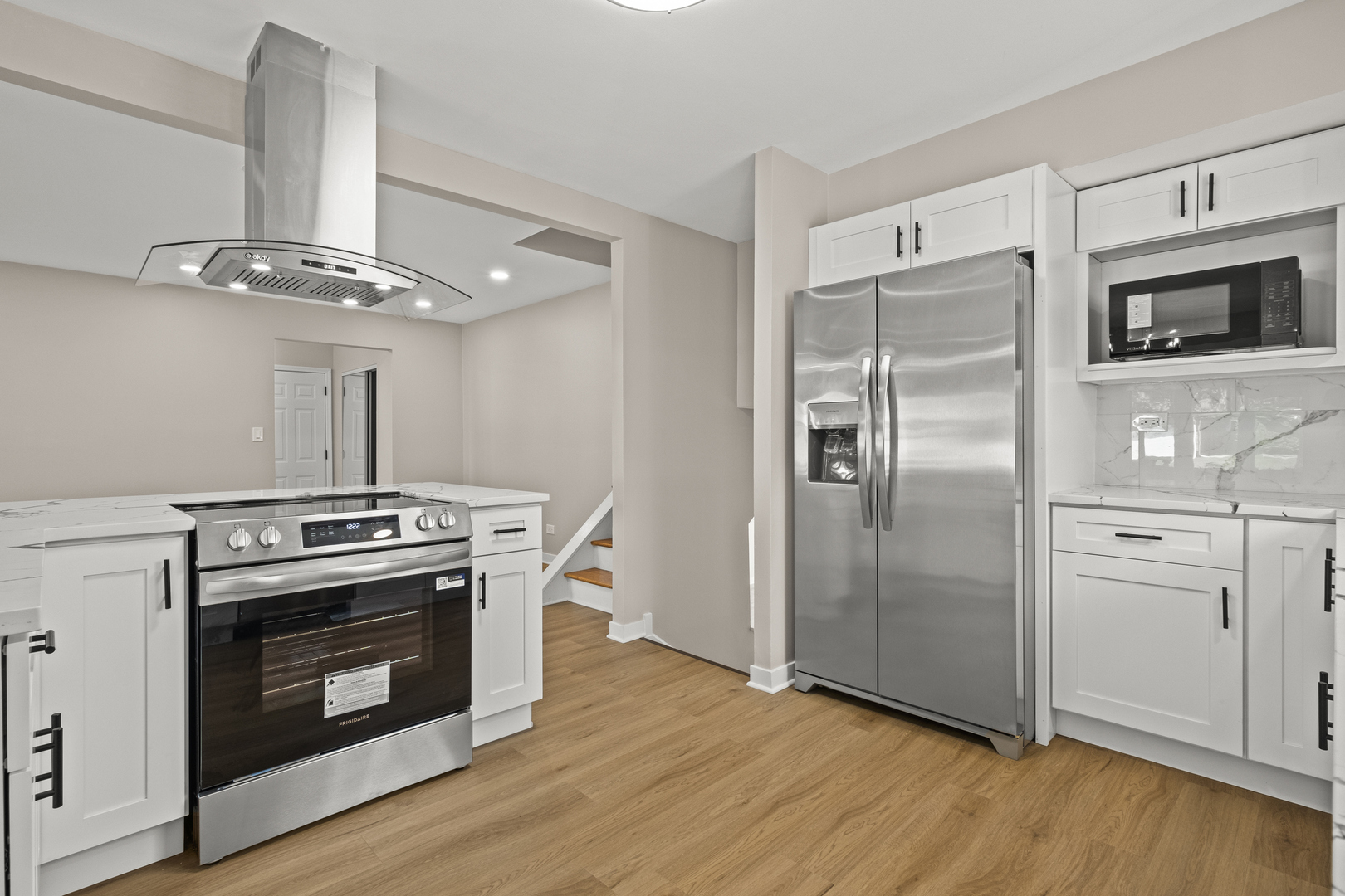 1813 West Pheasant Trail Mount Prospect, IL 60056 - Photo 7 of 31 a kitchen with stainless steel appliances a stove a microwave and a refrigerator