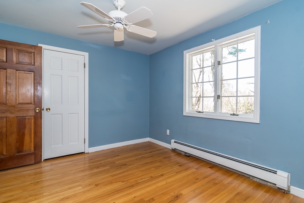 116 Stock Farm Road Sudbury, MA 01776 - Photo 12 of 31 wooden floor in an empty room with a window