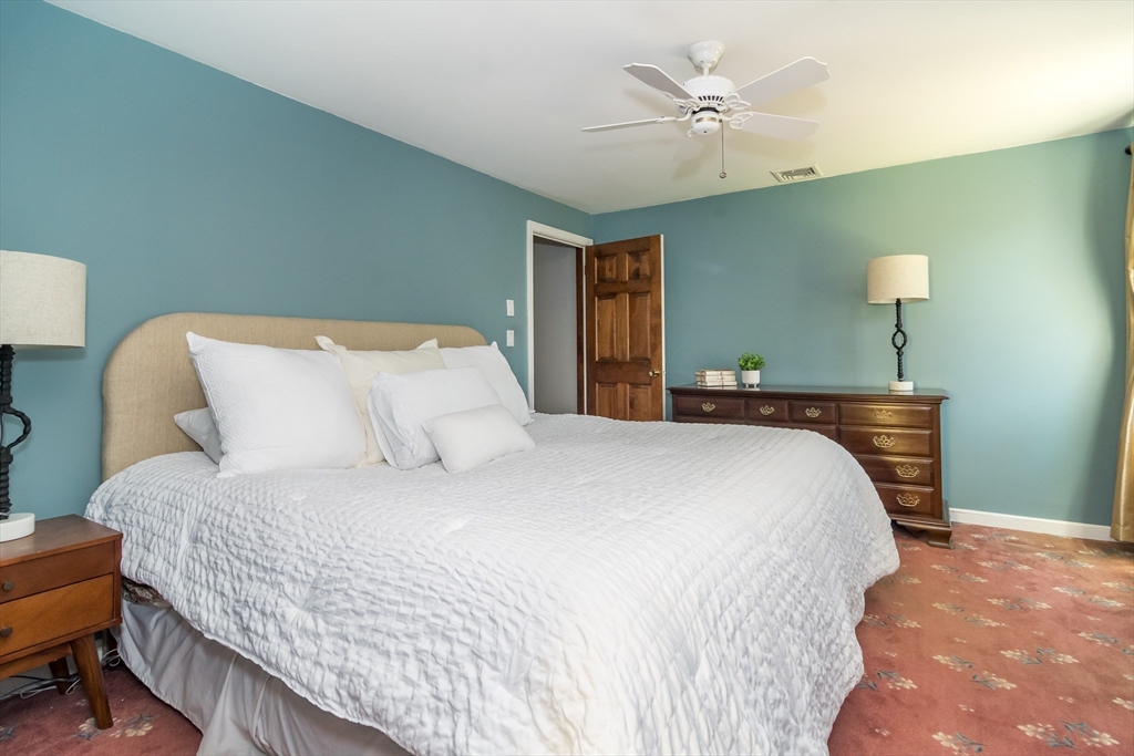 116 Stock Farm Road Sudbury, MA 01776 - Photo 14 of 31 a bedroom with a bed and a ceiling fan