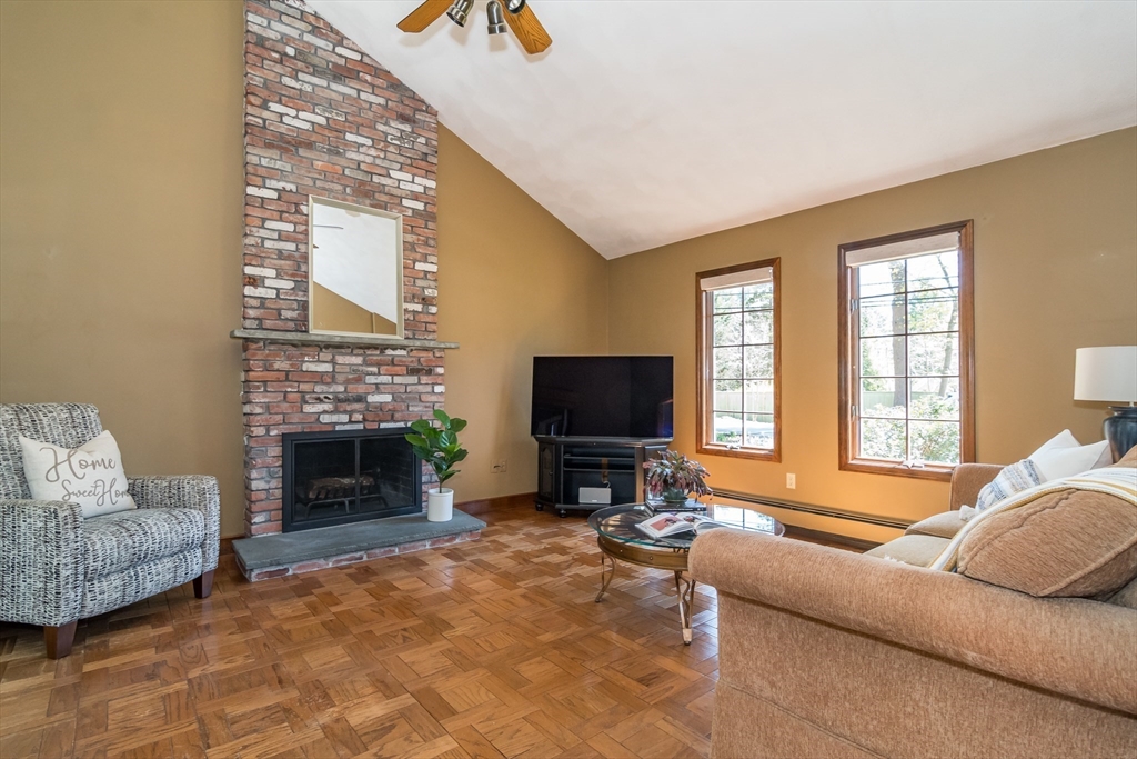 116 Stock Farm Road Sudbury, MA 01776 - Photo 5 of 31 a living room with furniture a flat screen tv and a fireplace