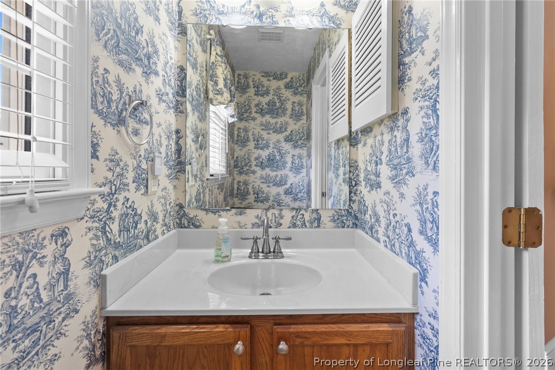 28 Coyt Circle Spring Lake, NC 28390 - Photo 17 of 41 a bathroom with a sink and a mirror