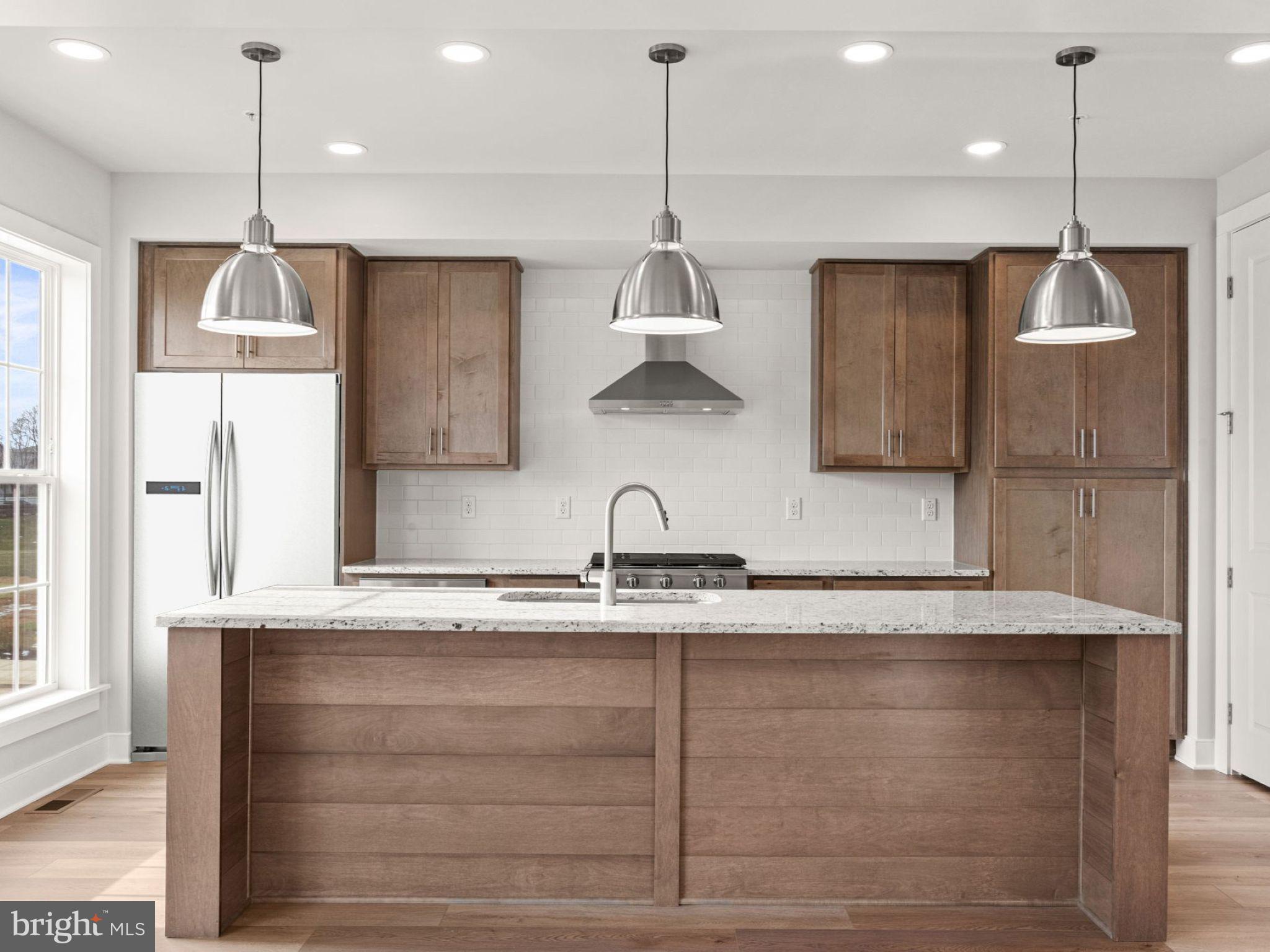 3 Sage Street Carlisle, PA 17015 - Photo 9 of 41 a kitchen with stainless steel appliances granite countertop a sink a refrigerator and a window