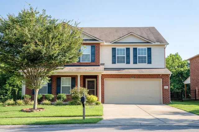 a front view of a house with a yard