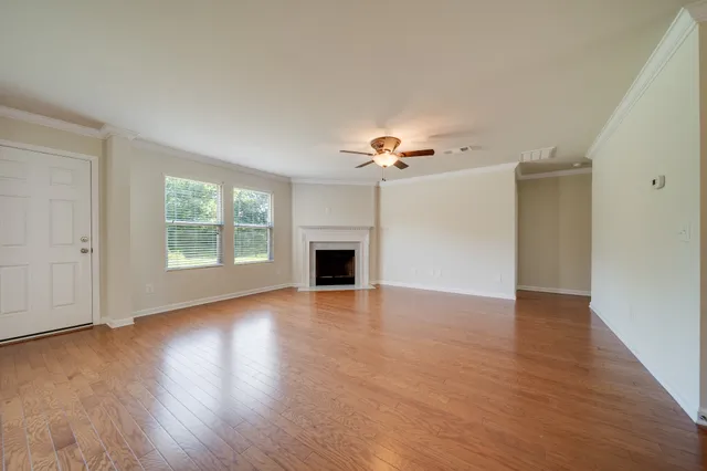 wooden floor in an empty room with a window