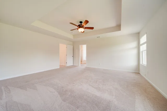 a bathroom with a sink a toilet a mirror and shower