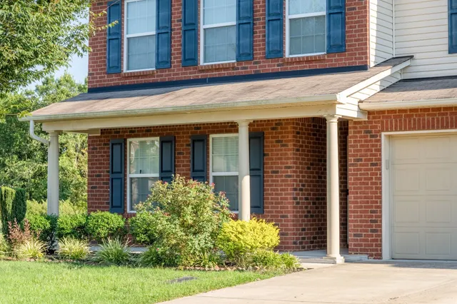 a front view of a house with a garden