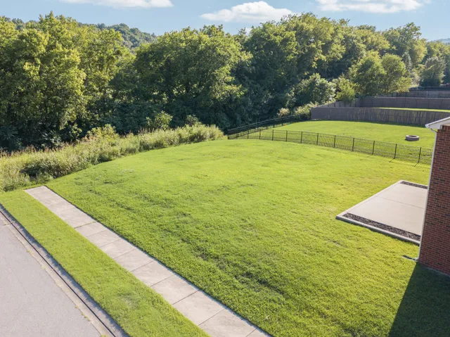a view of a house with swimming pool and yard